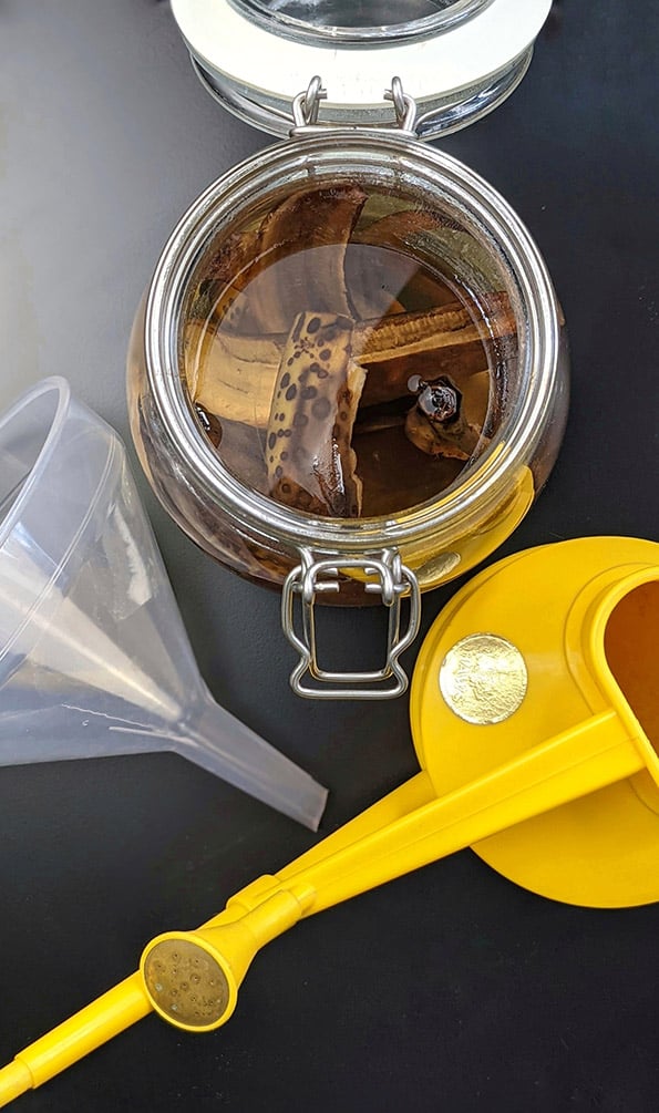 banana water equipment, mason jar, watering can and a funnel