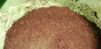 If soil or compost is sticking around the sides you can wash it off when you water in
